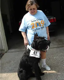 Elderly woman and large black dog